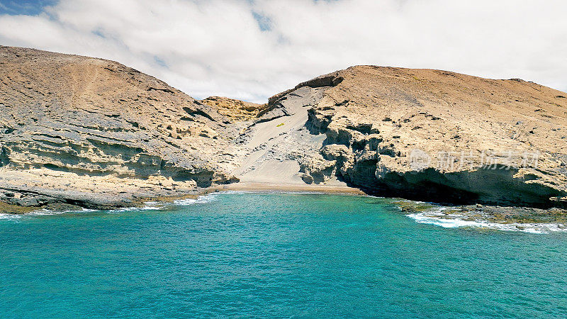 Aerial view of the hidden cove beach "La Rajita" at the natural reserve of "Monta?a Pelada" in Tenerife (Canary Islands). Drone shot